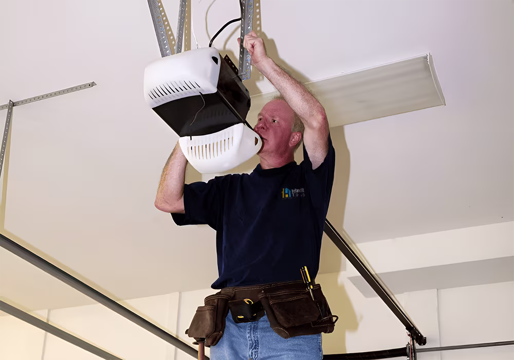 Handyman installing a garage door opener on the ceiling in Doral, Fl